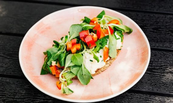 Delicious open-faced sandwich with fresh vegetables on whole grain bread, perfect for a healthy meal.
